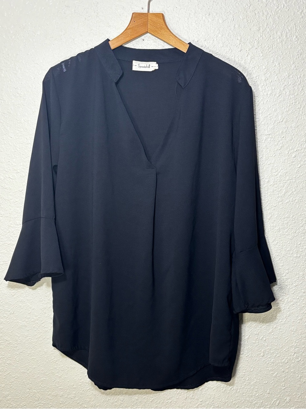 Spadehill blouse features distinctive flare bell sleeves, V-neckline. Women’s L